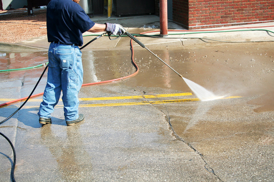 A Crew Member Cleans The Painted Street Markings Crew Member Cleans The Painted Street Markings
